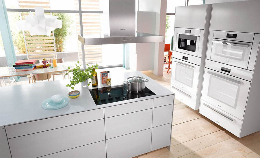 white open kitchen cabinet with ovens